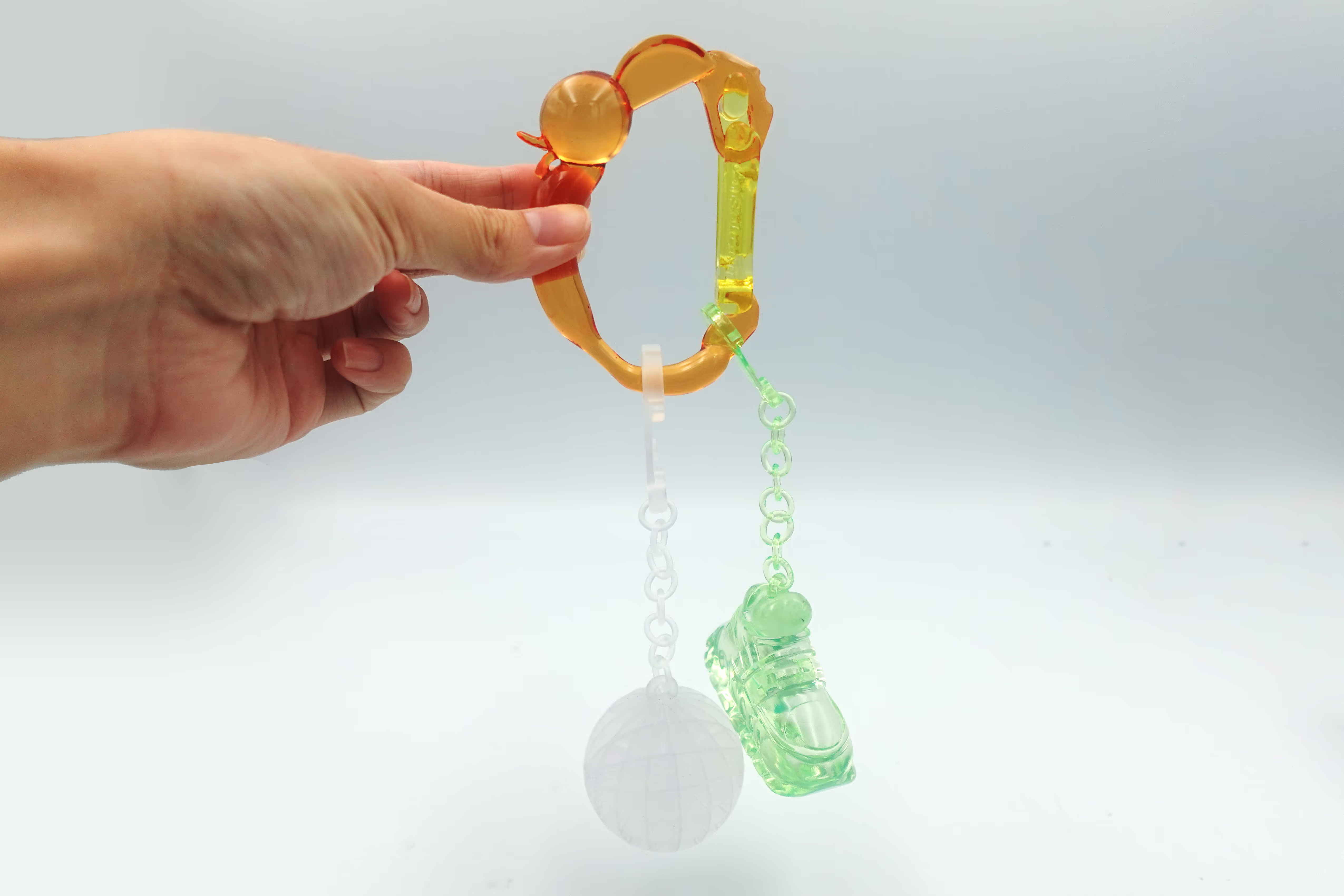 Custom 3D printed Christmas ornaments handing from a 3D printed carabiner
